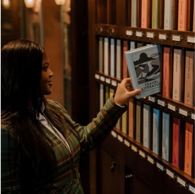 Receptionist collecting a room key at the Fife Arms hotel in Braemar, Scotland